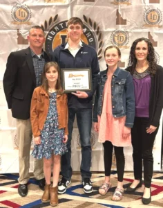 Asher Williams (center) and family; coach and dad Nathan Williams, sisters Daisy and Skylee and mom Star.